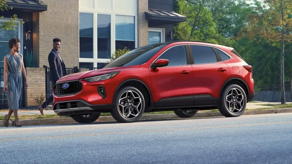 Ford Escape 2026 rouge garé devant une maison moderne.